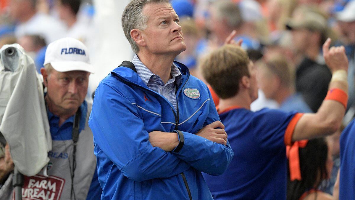Florida athletic director Scott Stricklin, center, watches from the sideline during the second...